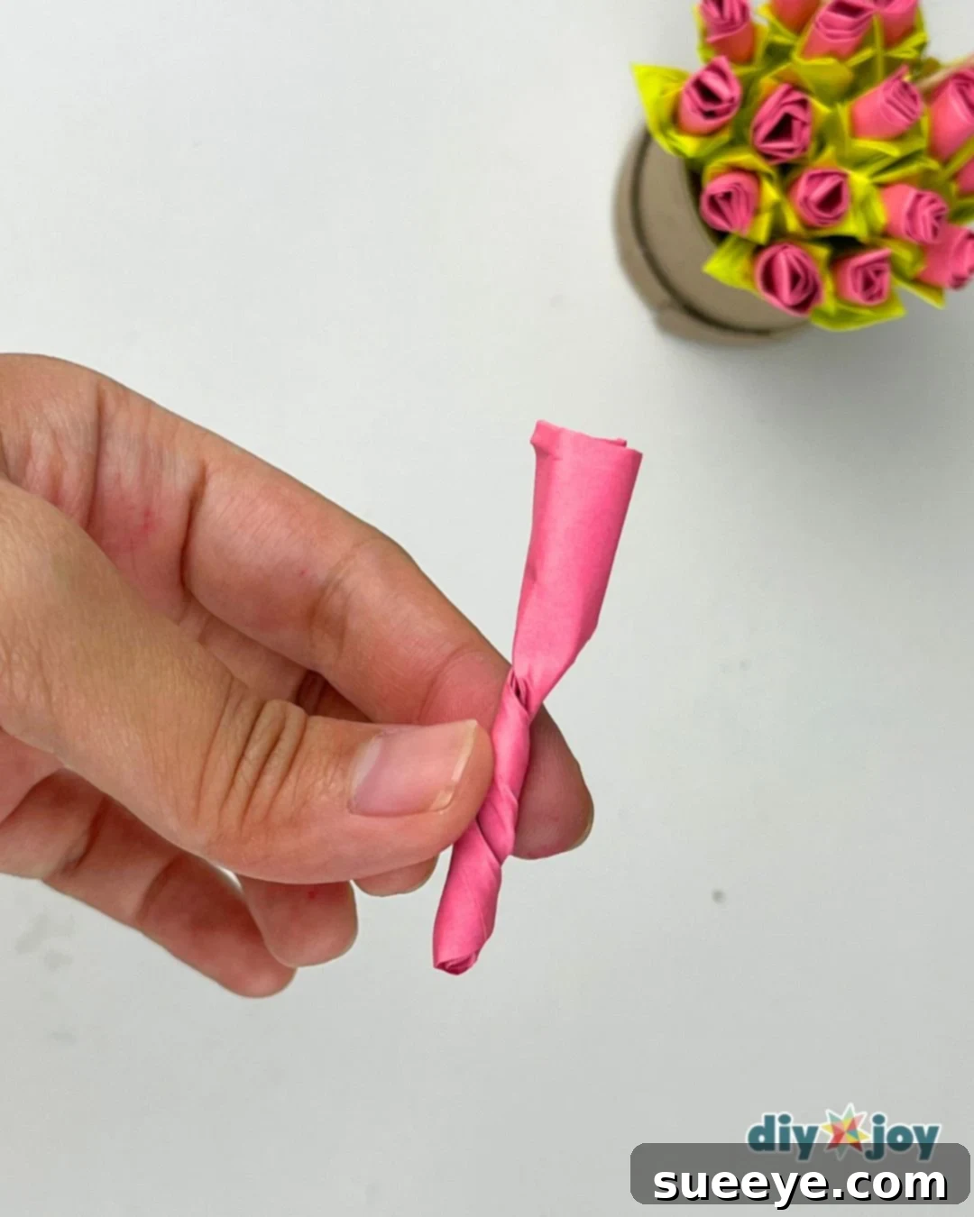 Technique for twisting the base of a rolled sticky note to create a beautiful paper rose