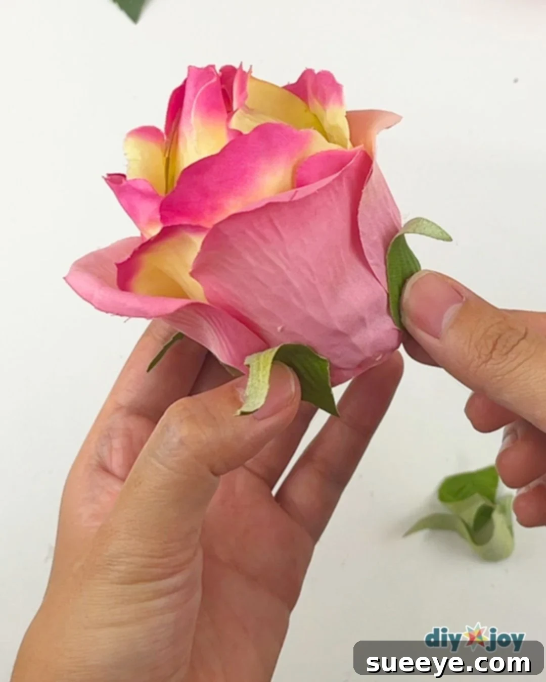 Gluing small sepals around the base of the flower tea light candle