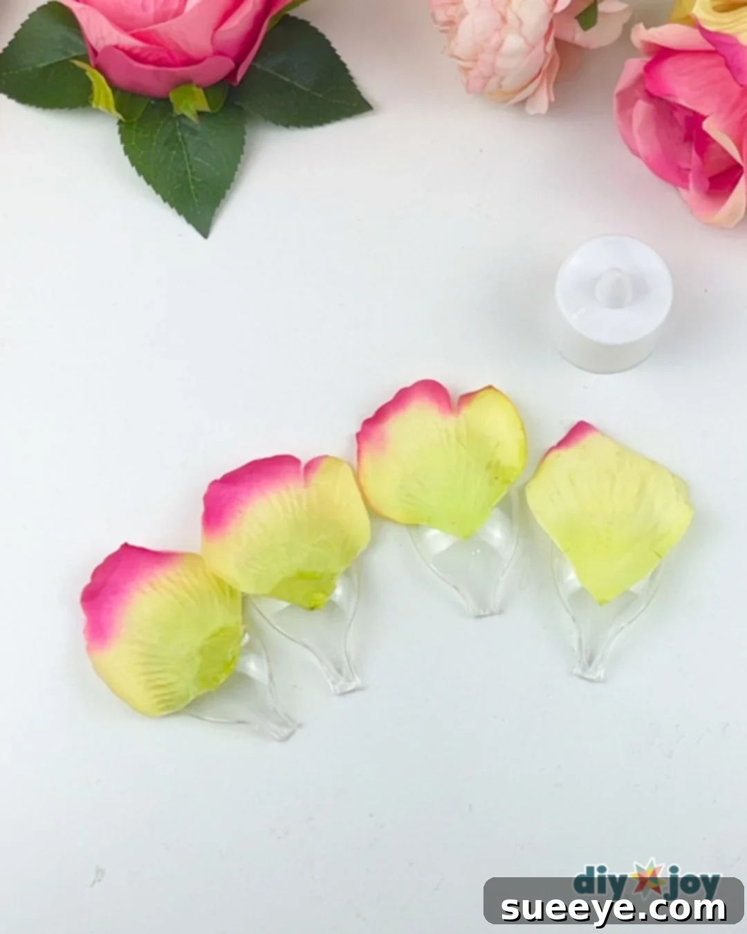 Gluing large yellow petals to the back of plastic spoons for a flower light