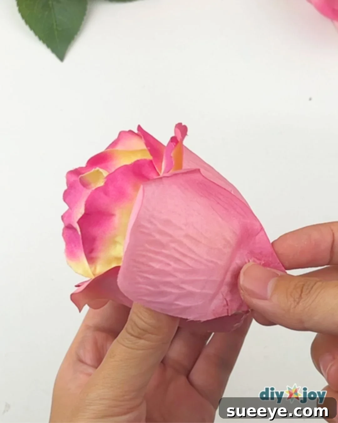 Adding contrasting pink petals to the floral tea light arrangement