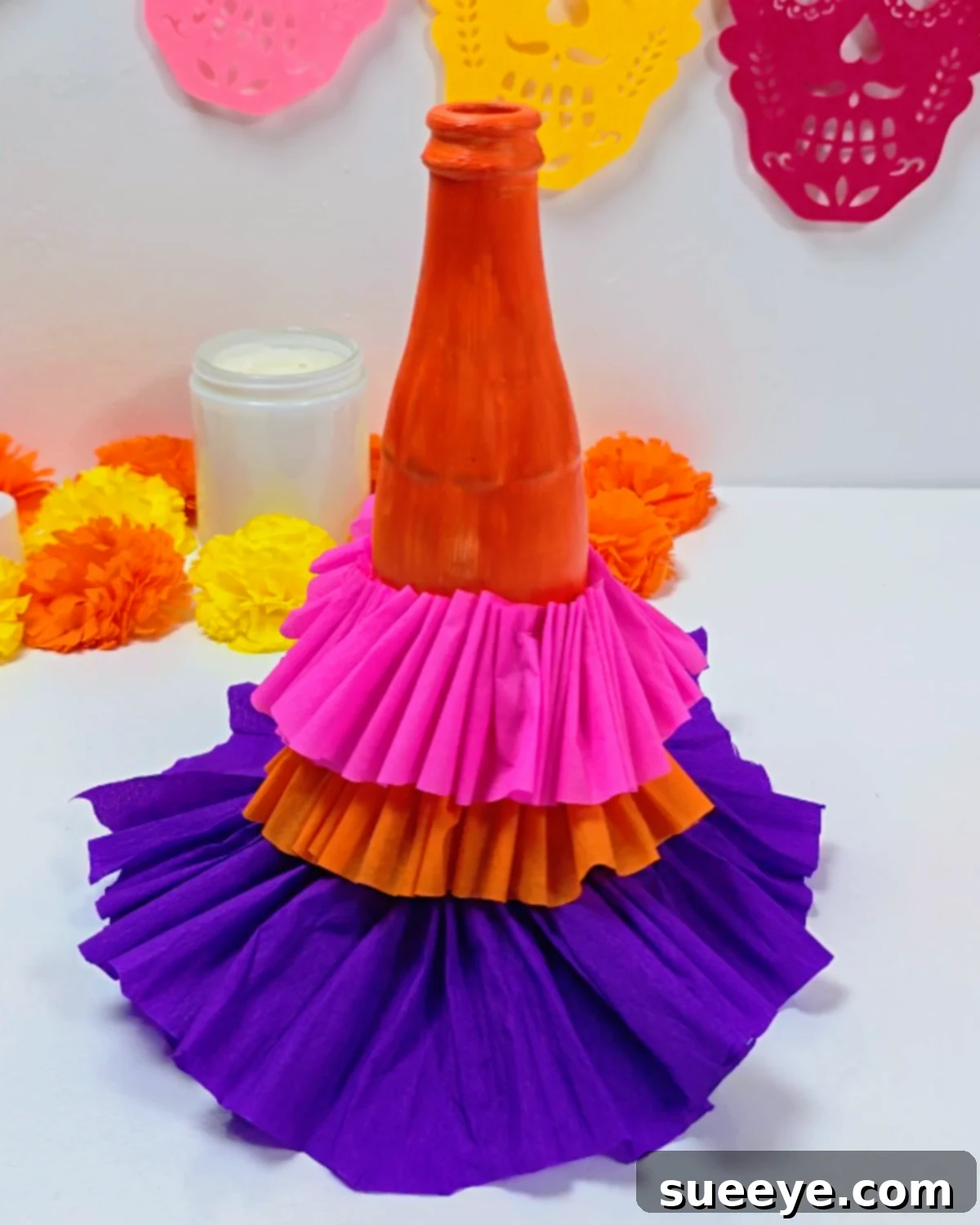 Craft a La Catrina from a Coca-Cola Bottle 4 Easy La Catrina With Crepe Paper - Attaching the gathered skirt layers to the bottle