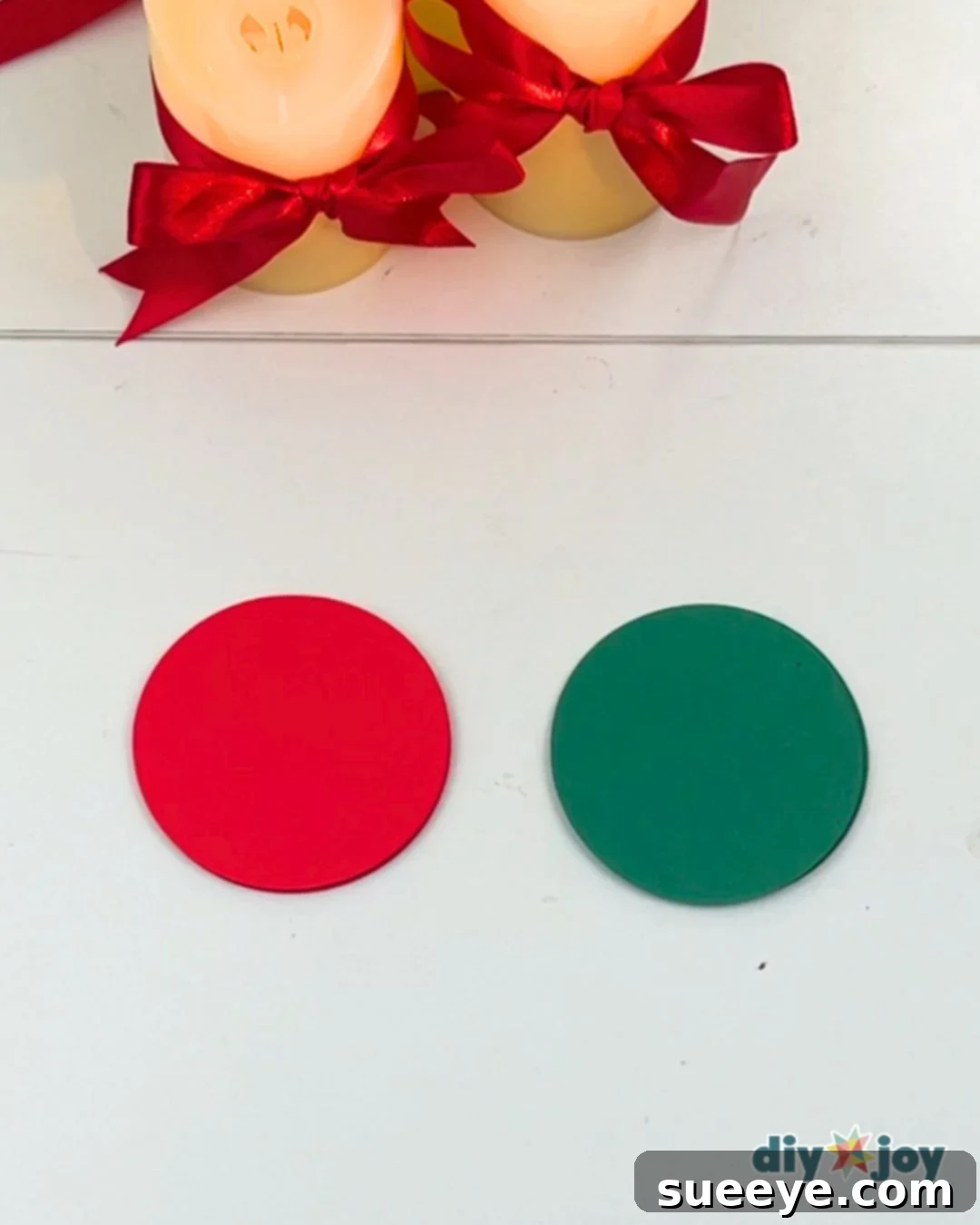 Make Easy Paper Christmas Ornaments 3 Paper Christmas Craft for Kids - Close-up of cutting circles from folded paper.