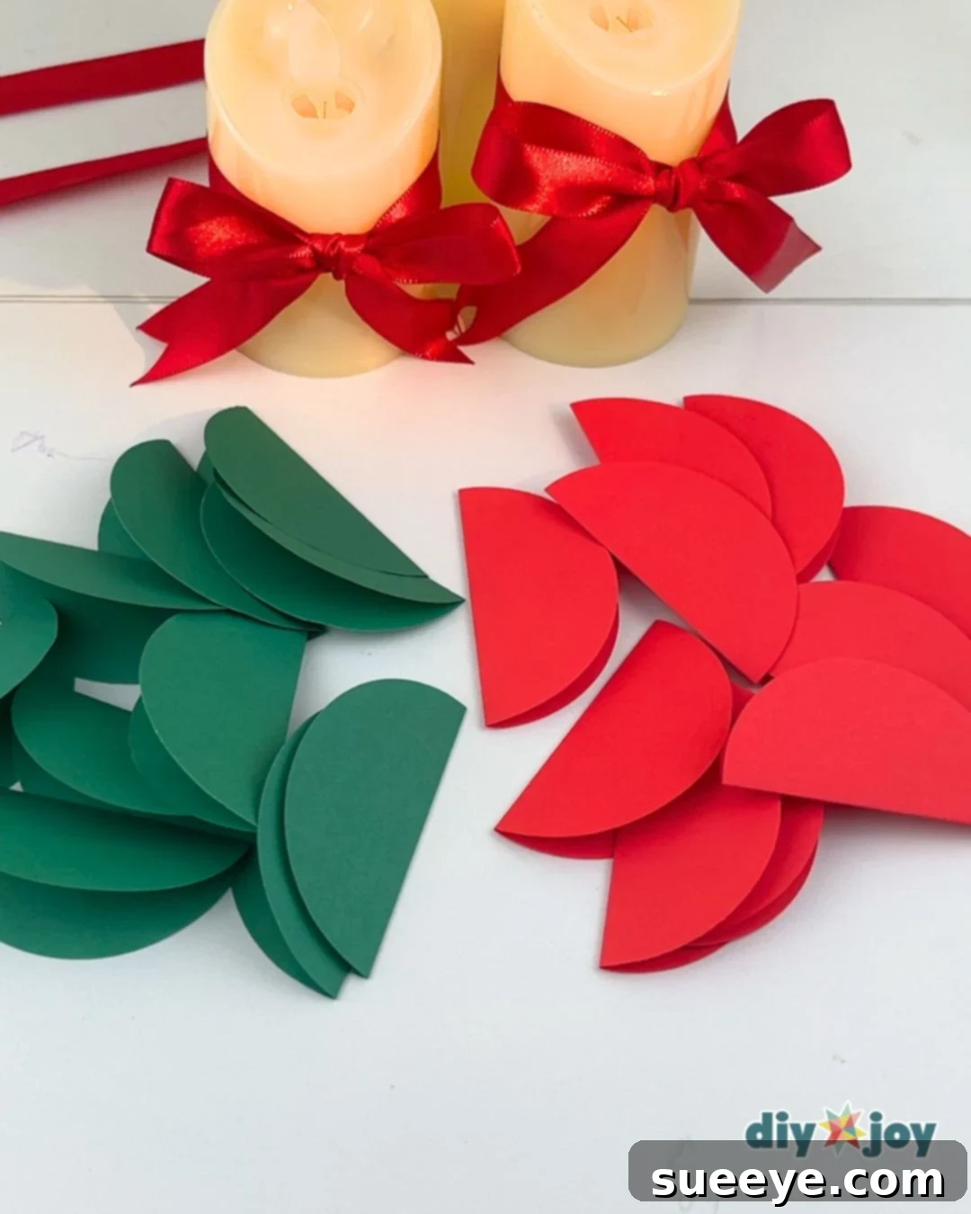 Make Easy Paper Christmas Ornaments 4 Kids Christmas Craft - A hand folding a single paper circle in half.