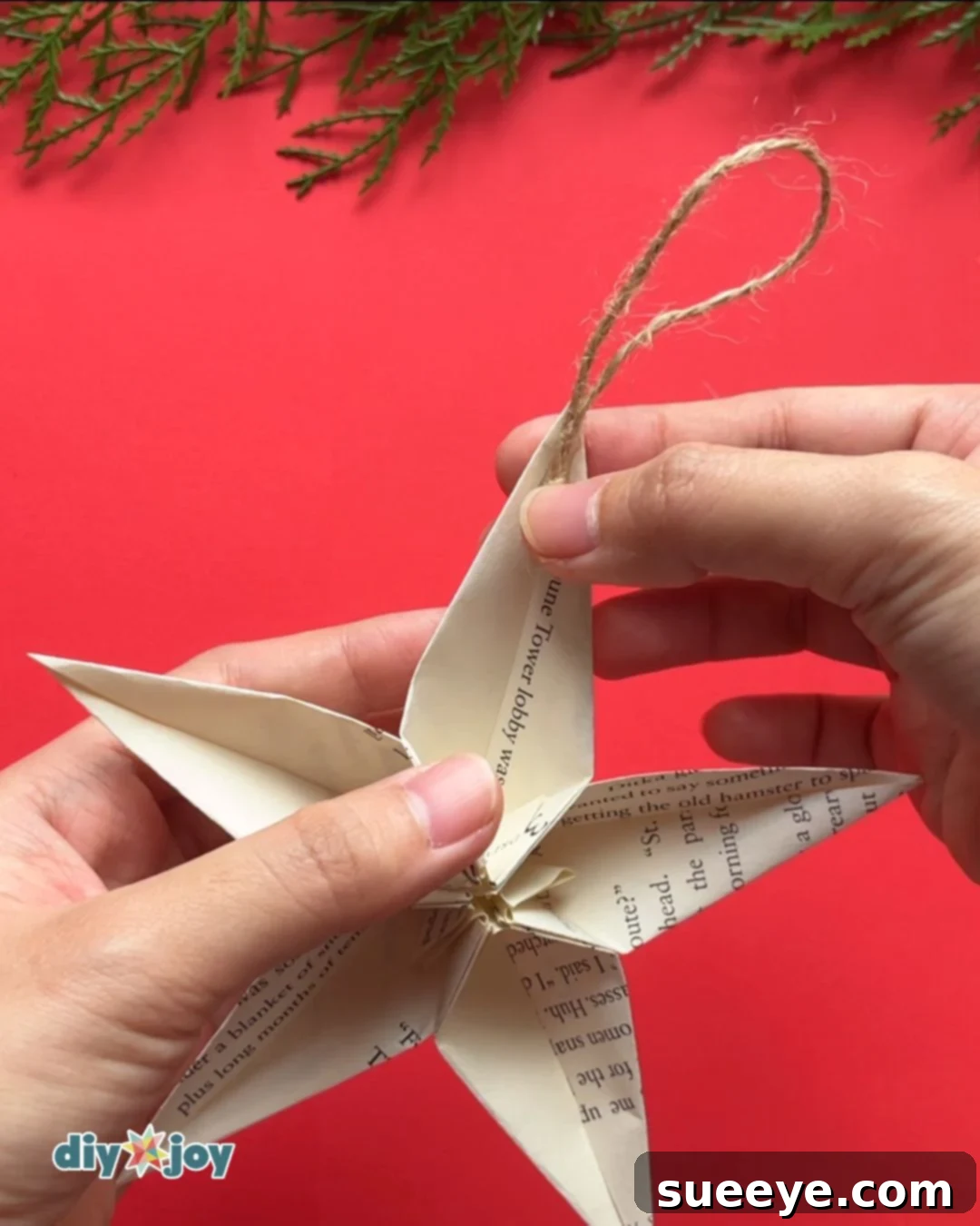 Origami star instruction step 9: adding string for hanging