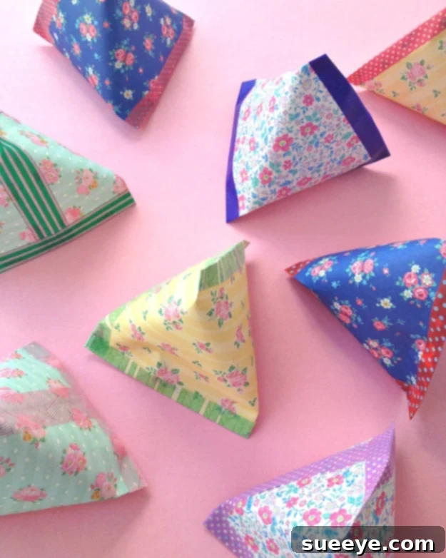 DIY pyramid paper pouch crafted from leftover wrapping paper, perfect for small gifts like jewelry or candies.