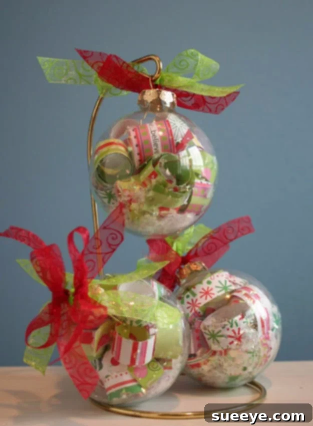 Clear Christmas ornament filled with shredded wrapping paper scraps and faux snow for a personalized touch.