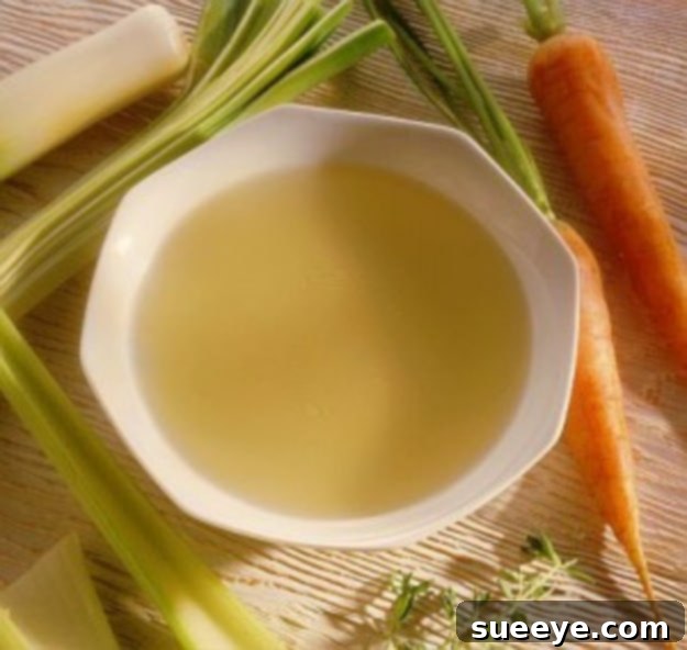 Homemade Chicken Broth for Sick Dogs - Comfort Food Bowl of homemade chicken broth for dogs, a soothing remedy for sick pets.