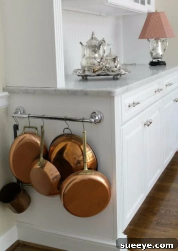 Towel Bar Pot Lid Organizer Towel bars installed inside a cabinet door for organizing pot and pan lids.