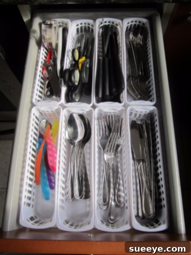 Cutlery Drawer Organizer Kitchen drawer with cutlery neatly organized using dividers.