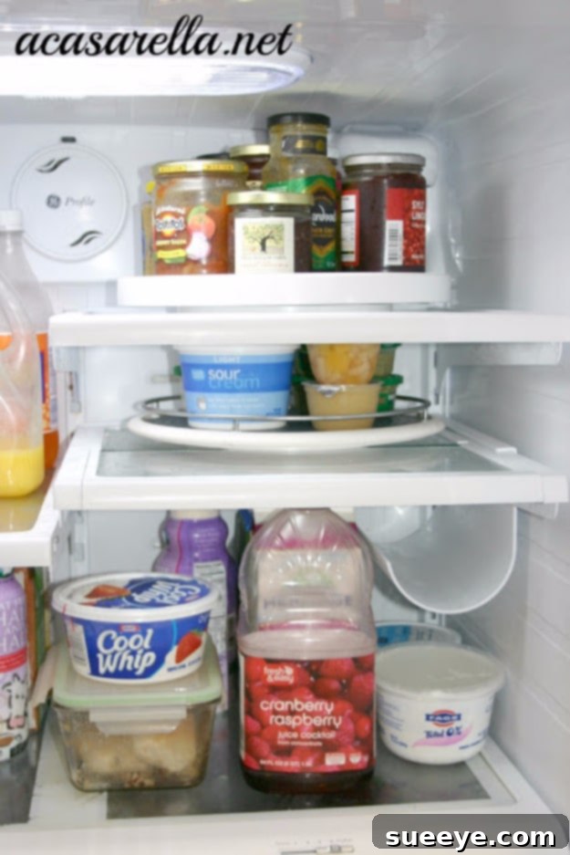 Lazy Susan Kitchen Organizer Lazy Susan organizing spices and condiments in a kitchen cabinet.