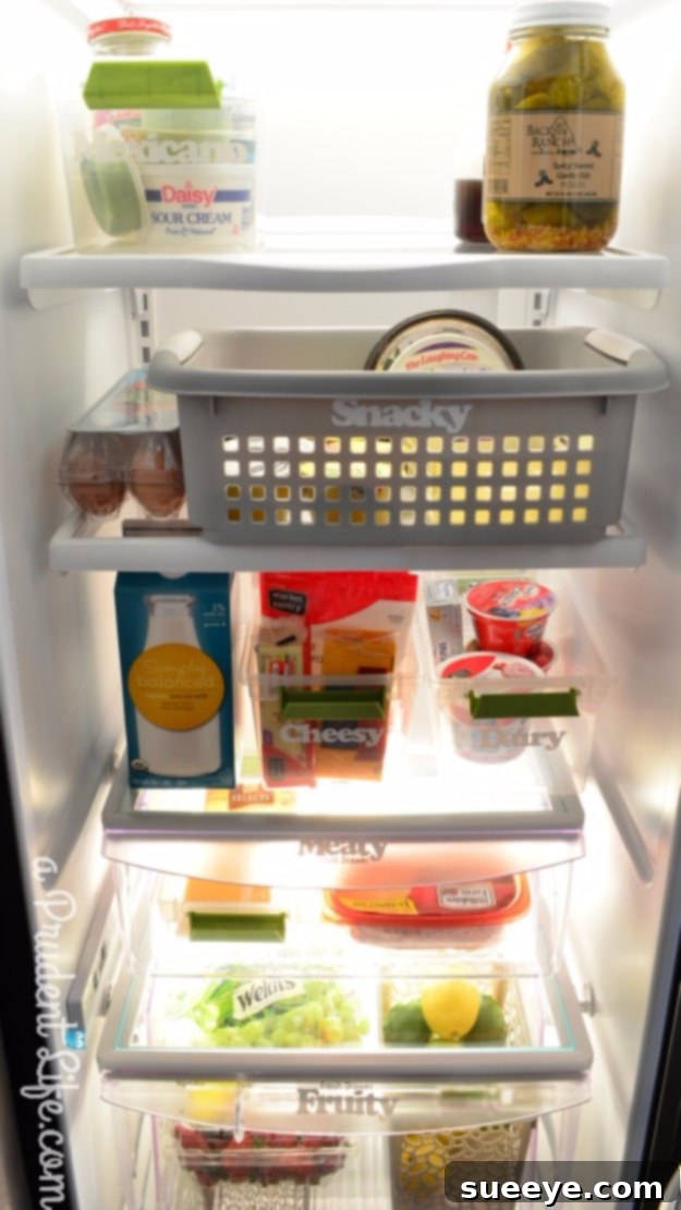 Comprehensive Refrigerator Organization Immaculately organized refrigerator with clear containers and designated zones for food items.