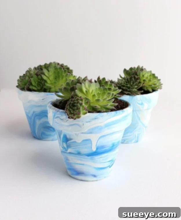 DIY Marbled Terra Cotta Pots with Nail Polish Beautifully marbled terra cotta pot in shades of blue and white, created with nail polish