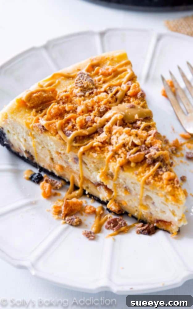 Peanut Butter Butterfinger Cheesecake: Candy Bar Dessert Indulgent Peanut Butter Butterfinger Cheesecake with crunchy candy