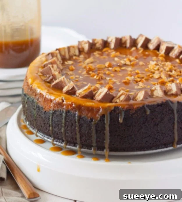 Snickers Cheesecake: Ultimate Candy Bar Dessert Decadent Snickers Cheesecake with chocolate, caramel, and peanuts