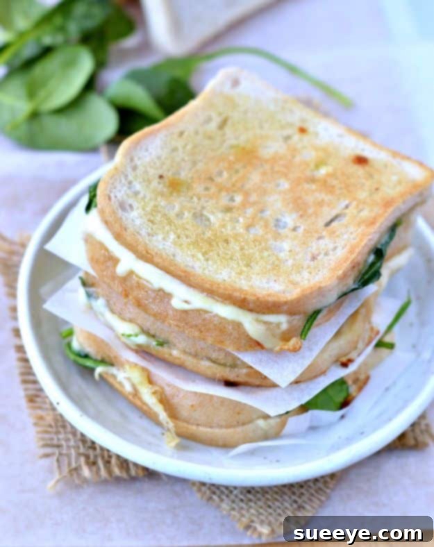 A Spinach Stuffed Grilled Cheese Sandwich cut in half