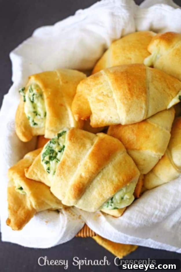 Golden Cheesy Spinach Crescents on a baking sheet