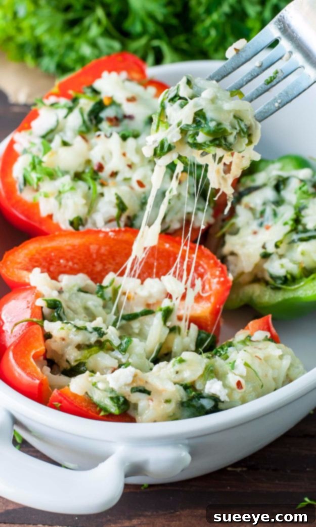 Baked Cheesy Spinach Stuffed Peppers with melted cheese