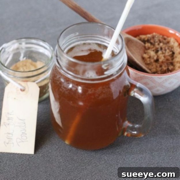 Homemade Birch Beer Recipe Homemade Birch Beer - A glass of dark birch beer with a frothy head.