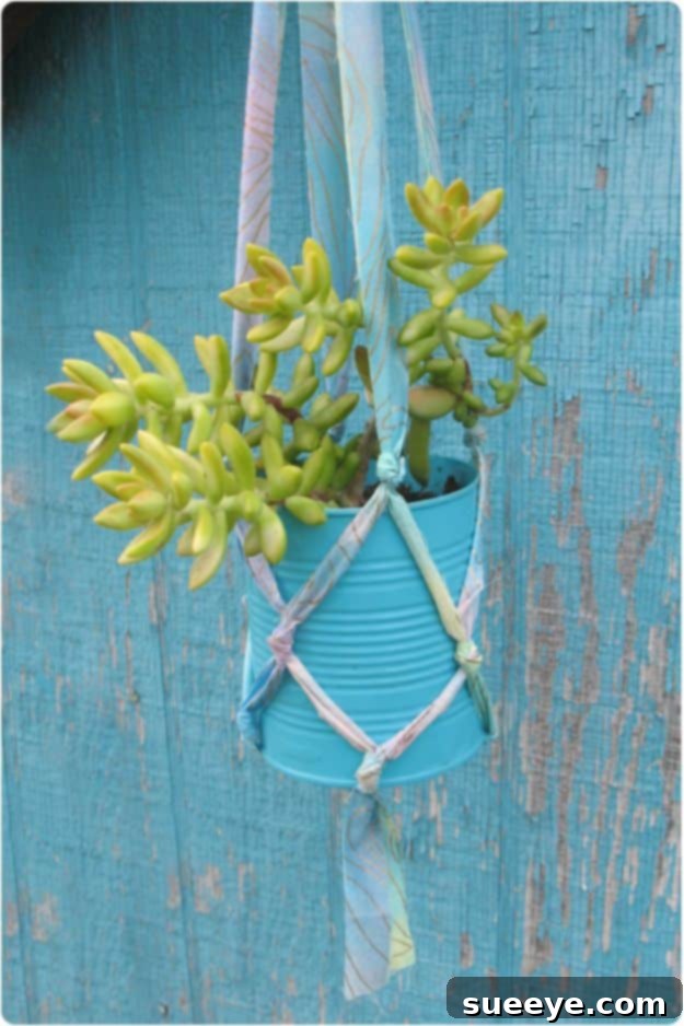 Add vertical interest to your garden or home with a stylish DIY Tin Can Hanging Planter. DIY Tin Can Hanging Planter for vertical gardening and small spaces