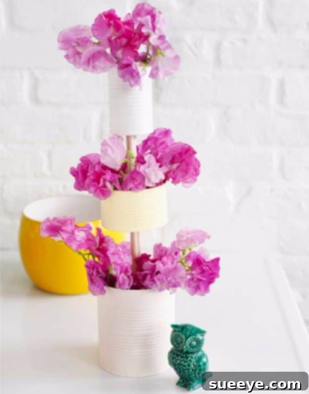 Construct a beautiful DIY Tiered Vase from tin cans to showcase your floral arrangements with height and dimension. DIY Tiered Vase Of Tin Cans for multi-level flower arrangements
