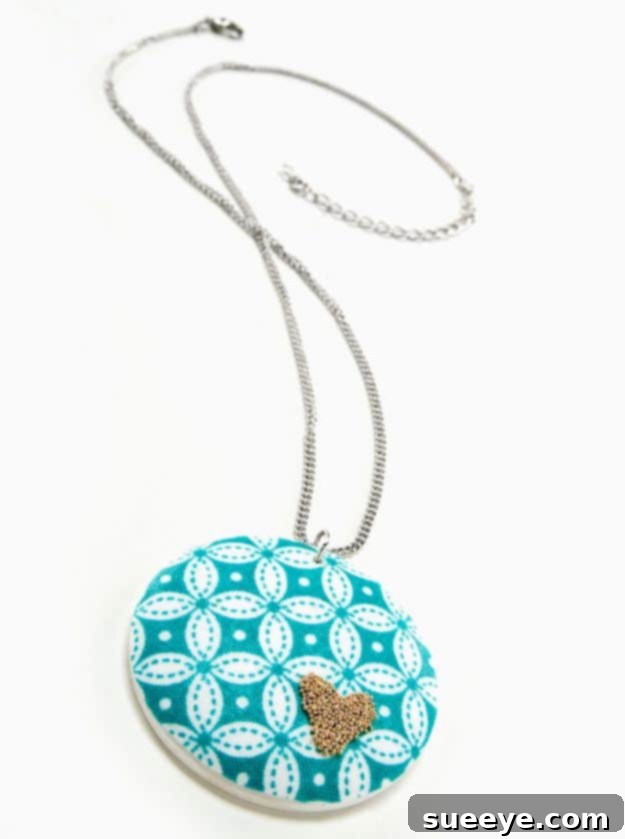 Gold beaded heart necklace with subtle fabric embellishments, a unique handmade accessory.