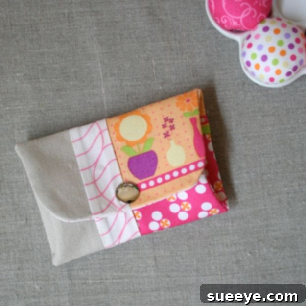 Small, rectangular snappy coin purse made from patterned fabric scraps, featuring a metal closure.