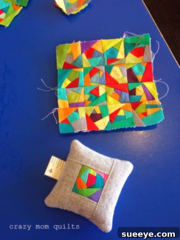 Classic square pincushion made from patchwork fabric remnants, for sewing essentials.