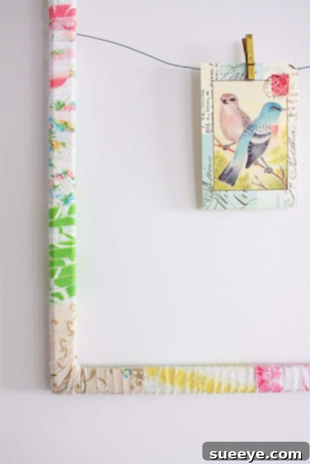 Photo frame wrapped with strips of vintage sheet fabric, adding a charming, colorful touch.