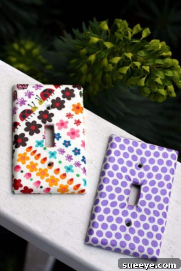 Light switch plate covered with patterned fabric, enhancing room decor.