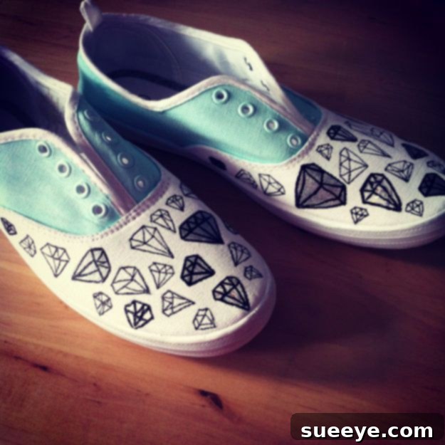 Modern canvas sneakers customized with a sharp, geometric diamond pattern using tape and fabric paint.