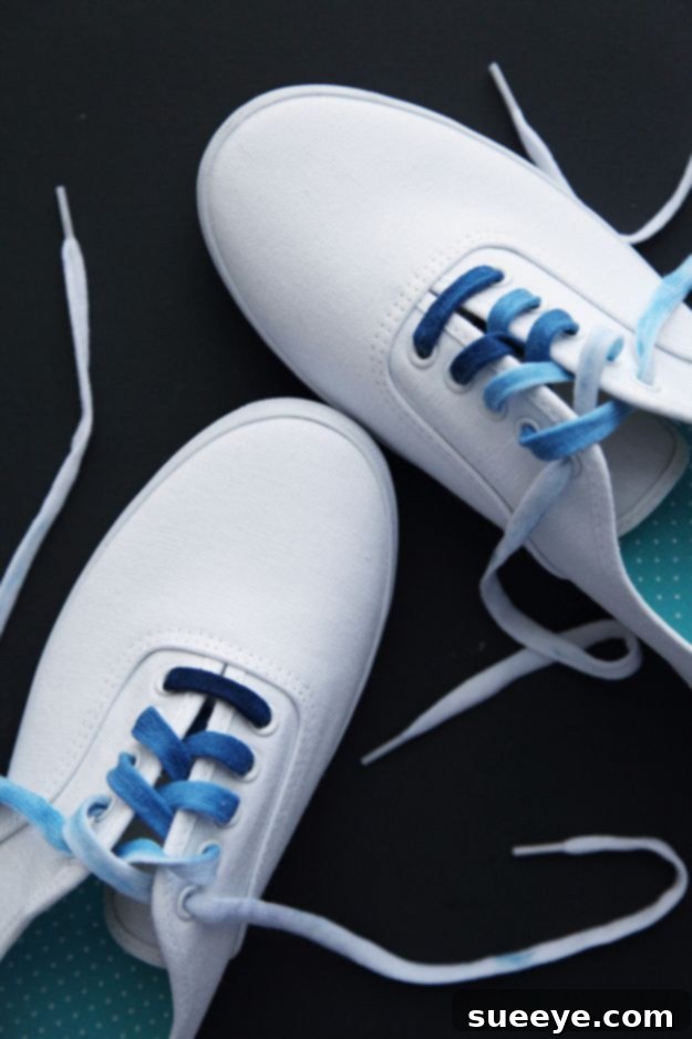 White shoelaces beautifully dyed with indigo to create a subtle ombre gradient effect.