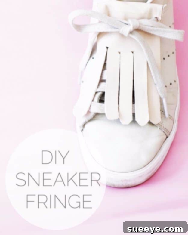 White sneakers customized with bohemian-style fringe detailing, adding texture and flair.