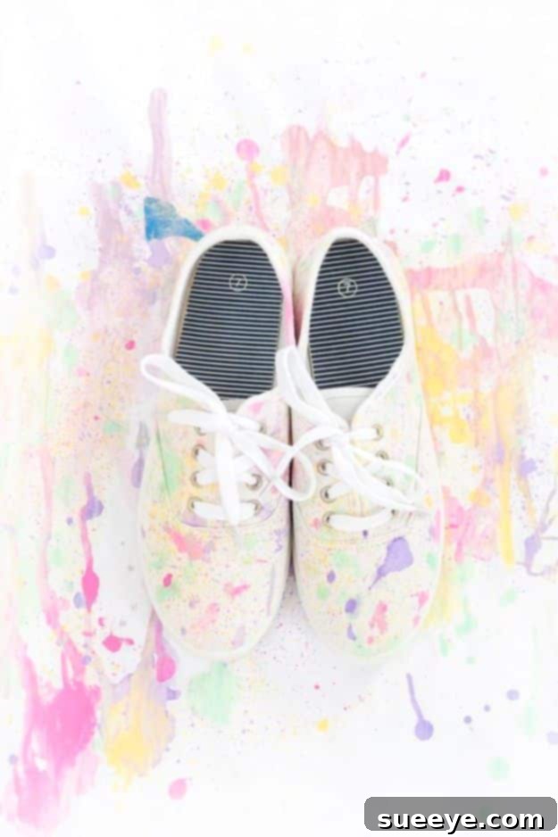 DIY Abstract Paint Splatter Shoes: Unleash your creativity with this artistic sneaker transformation. Fashionable white canvas shoes customized with an abstract multi-color paint splatter design.