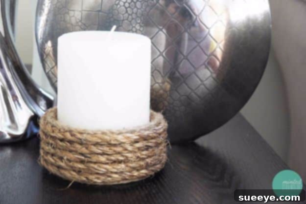 Rustic rope-wrapped candle holder, a simple DIY for a nautical or farmhouse aesthetic.