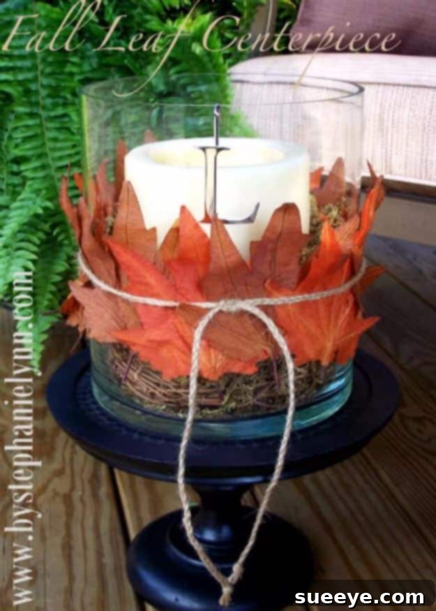 Pottery Barn Inspired Fall Leaf Hurricane Centerpiece Hurricane lamp decorated with fall leaves and twigs, inspired by Pottery Barn