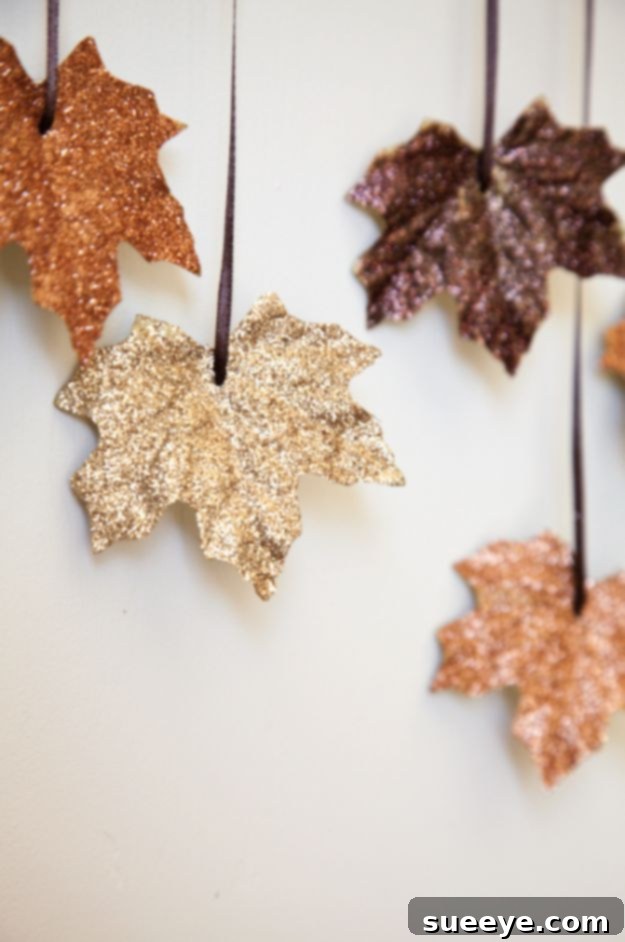 DIY Falling Leaves Garland Sparkling DIY garland with artificial fall leaves and ribbon