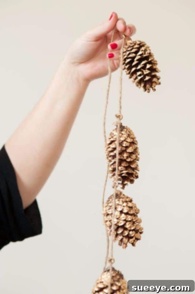 DIY Pine Cone Garland Handmade garland featuring glitter-dipped pine cones on a string