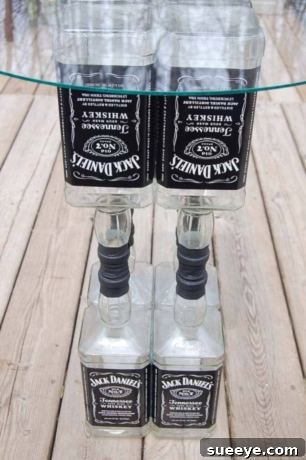 DIY Jack Daniel's Liquor Bottle Table: Unique Upcycled Furniture Project Fun DIY Ideas Made With Jack Daniels - Recipes, Projects and Crafts With The Bottle, Everything From Lamps and Decorations to Fudge and Cupcakes | Upcycled Jack Daniels Liquor Bottle Table Idea #diy #jackdaniels #recipes #crafts
