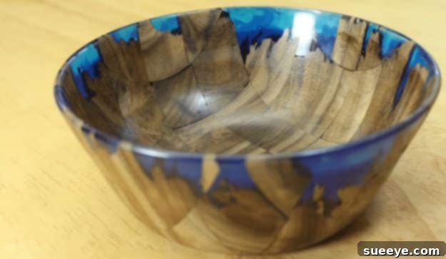 DIY Wood and Resin Bowl Artistic DIY wood and resin bowl, showcasing a mesmerizing blend of natural wood grain and colorful, clear resin.