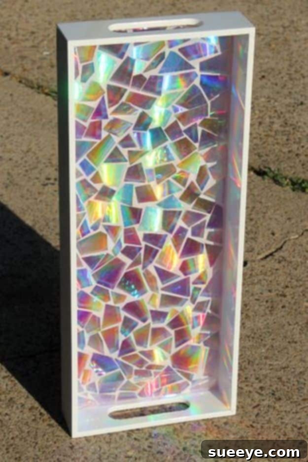 Mosaic Resin Tray Creative mosaic resin tray, repurposing materials like broken DVDs under a clear resin layer for a unique serving or display piece.