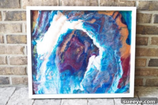 Poured Resin Wall Art Abstract poured resin wall art, creating fluid and mesmerizing patterns with layers of colored epoxy resin on a canvas or panel.