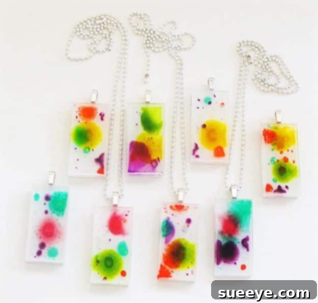 Resin and Ink Pendants Artistic resin and ink pendants, demonstrating vibrant and swirling abstract patterns created with alcohol inks in resin.