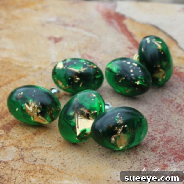 Gold Leaf and Emerald Resin Cabinet Knobs Elegant cabinet knobs made with emerald green resin and real gold leaf, perfect for an upscale DIY home decor upgrade.