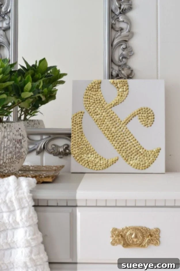 DIY thumbtack ampersand art, a creative Dollar Tree craft