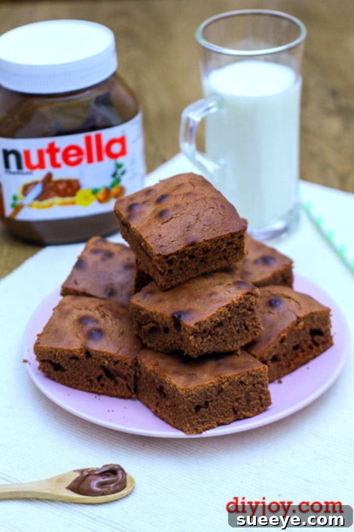Foolproof 3 Ingredient Nutella Brownies 2 Deliciously fudgy 3-ingredient Nutella brownies, perfectly baked and cut into squares, ready to be enjoyed.
