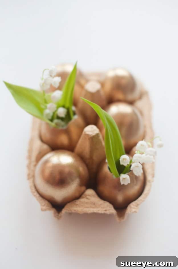 48 Creative DIY Easter Decor Projects 17 Elegant golden Easter eggshells repurposed as miniature vases for small flowers.