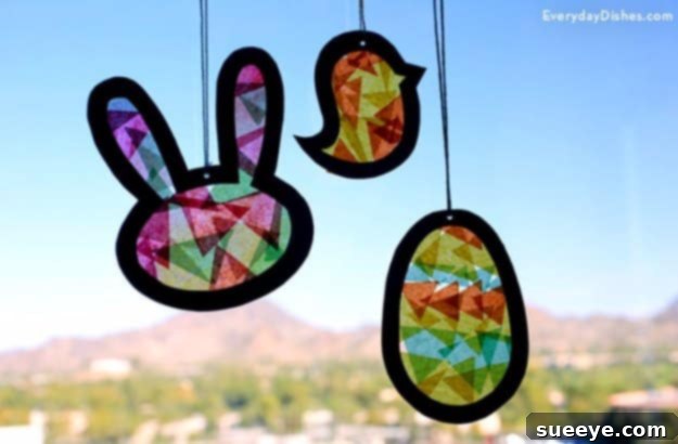 48 Creative DIY Easter Decor Projects 37 A vibrant Easter suncatcher, made from translucent materials in various spring shapes.