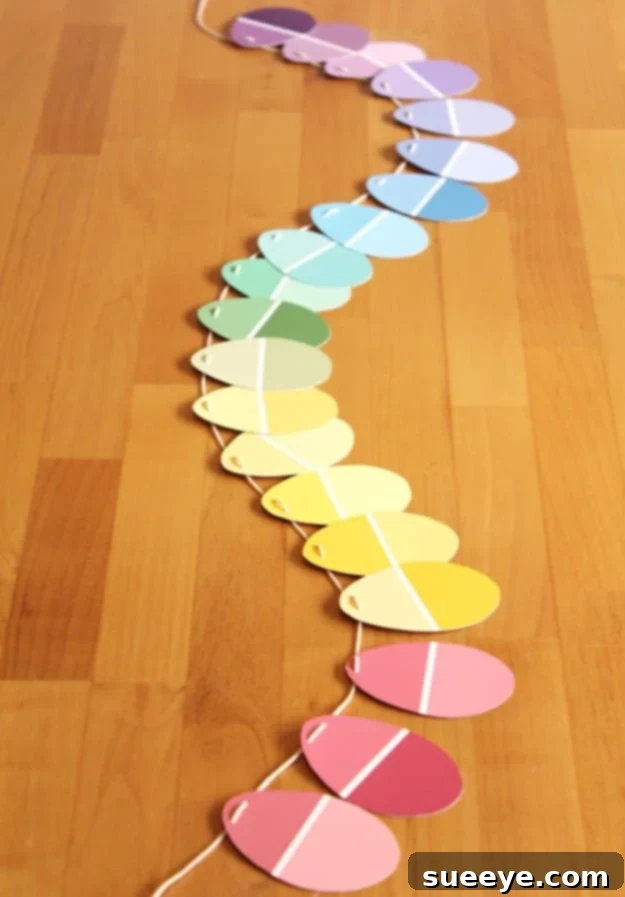 48 Creative DIY Easter Decor Projects 44 A festive garland made from colorful paint chips cut into Easter egg shapes.
