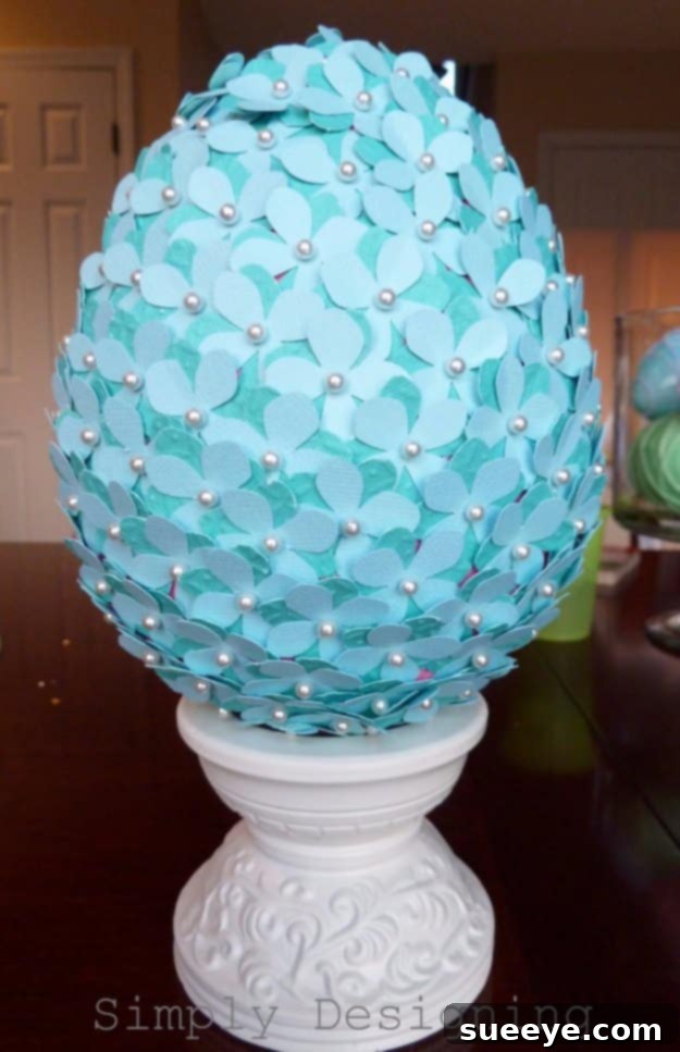 48 Creative DIY Easter Decor Projects 6 A topiary adorned with colorful paper flowers and small decorative eggs, perfect for Easter.