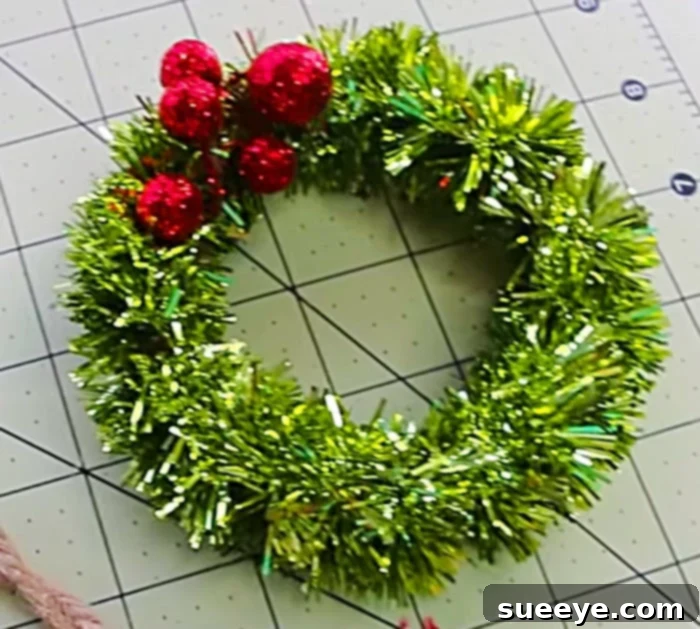 Make mini DIY wreath ornaments from Mason Jar Lids Dollar General - adding embellishments